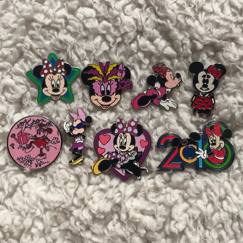 A group of Minnie Mouse Disney pins photographed for a US resale marketplace listing